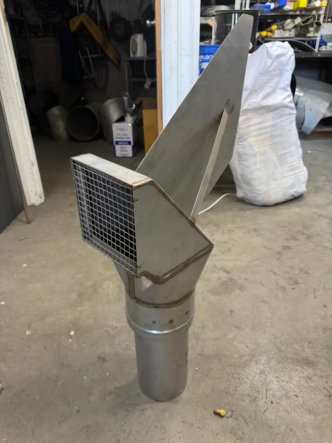 Stainless steel forced induct (wind-vane) cowl with a mesh-screened inlet, in a workshop